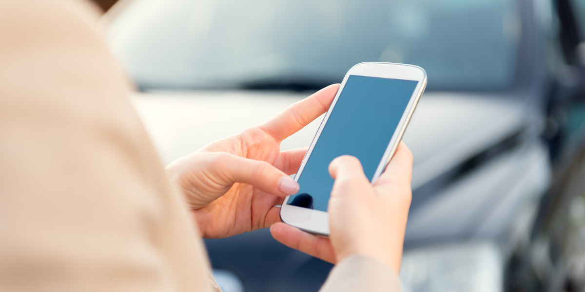 A woman looking on her phone while outside