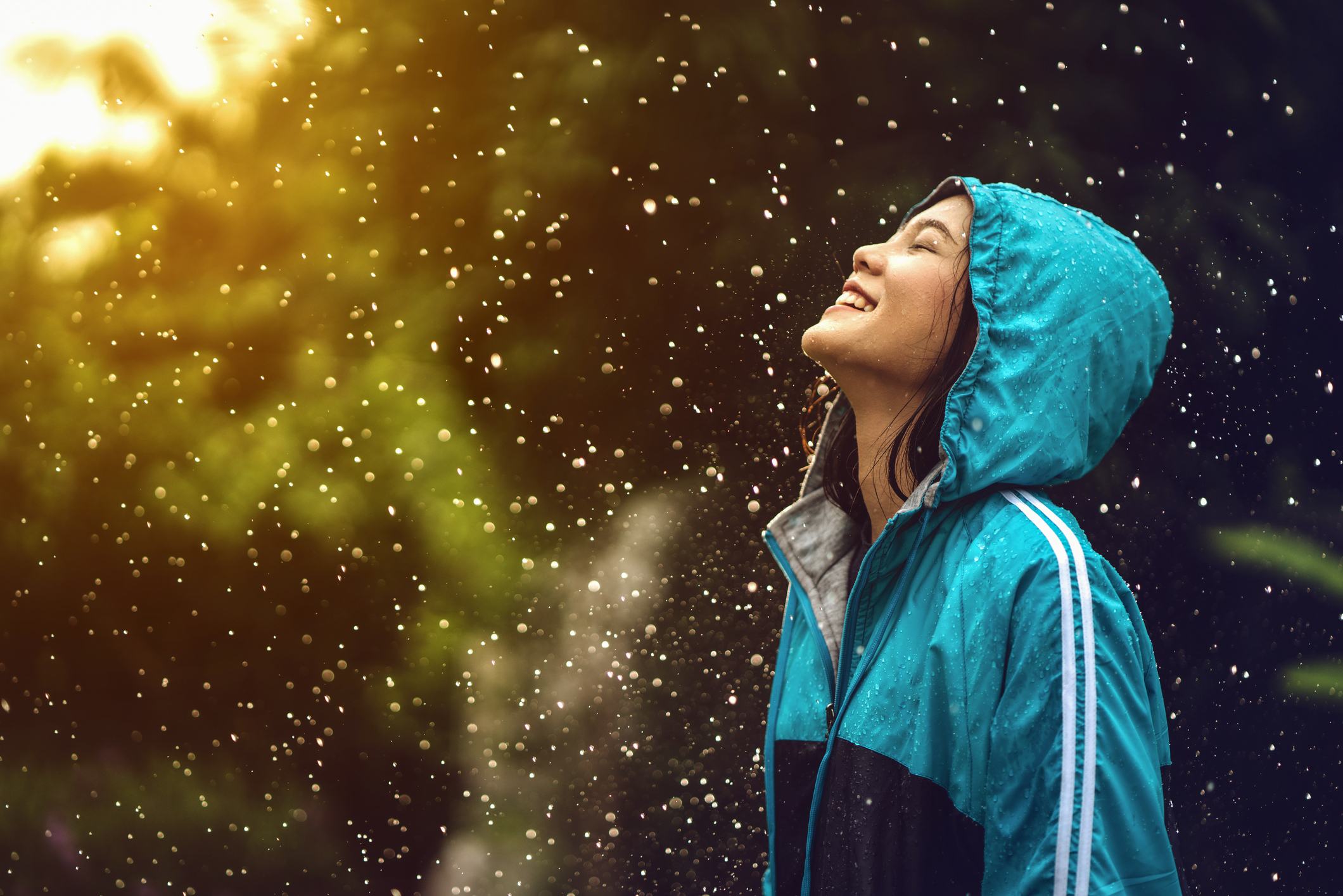 Happy asian woman wearing a raincoat outdoors