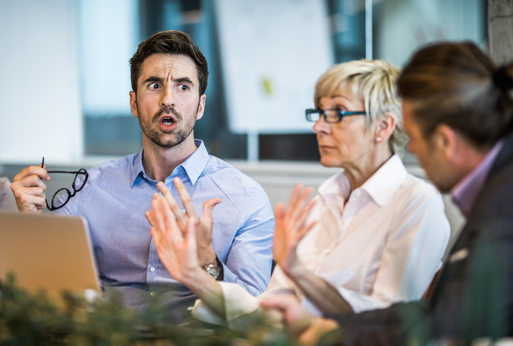 Young businessman arguing with his colleague on a meeting in the office