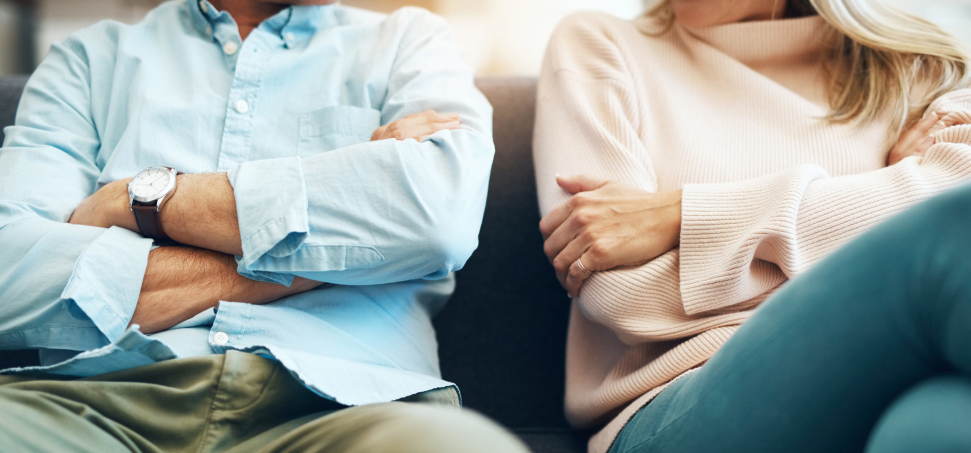 Cropped shot of an unrecognizable mature couple sitting on the sofa with their arms folded after an argument