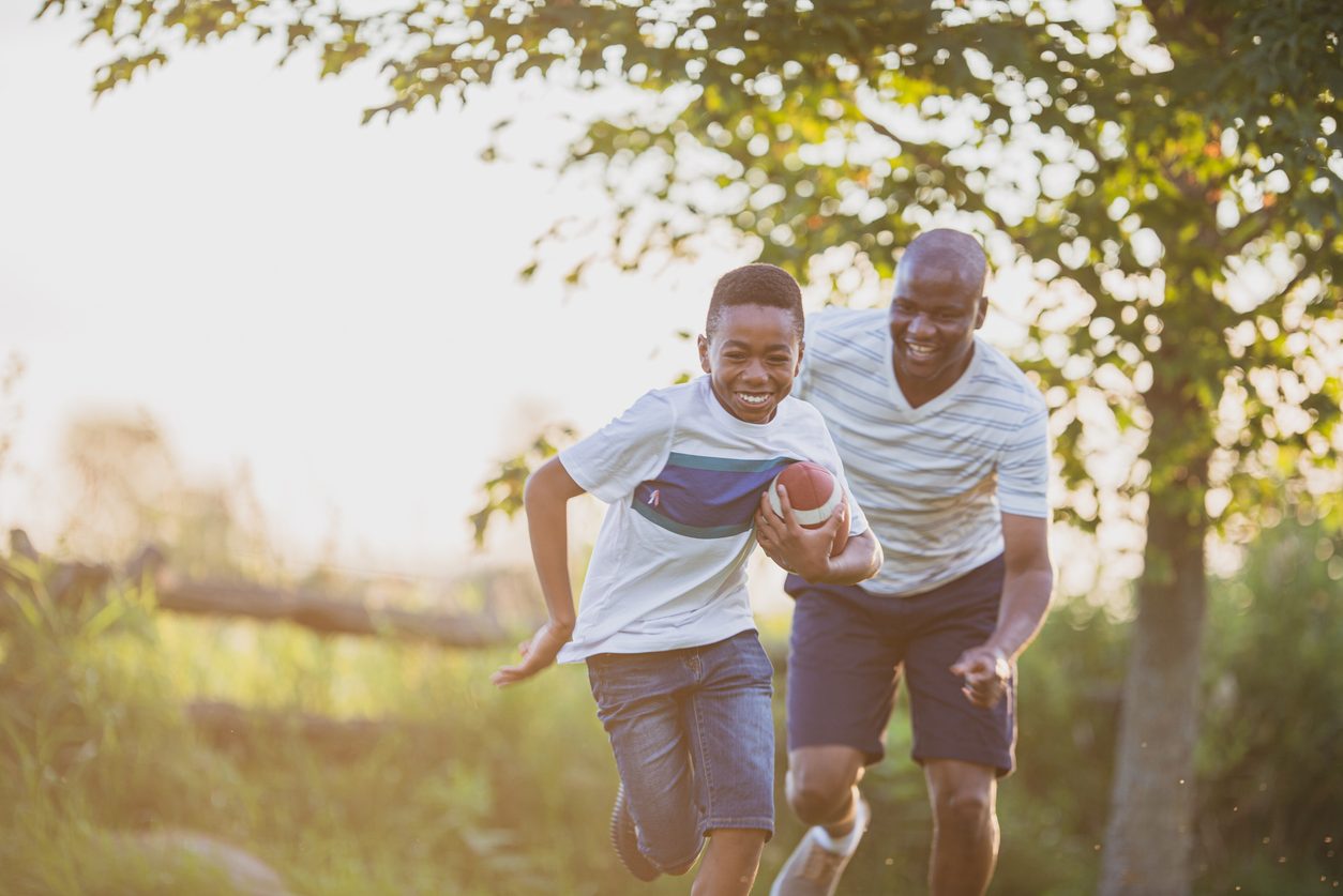 Father and son playing backyard football
