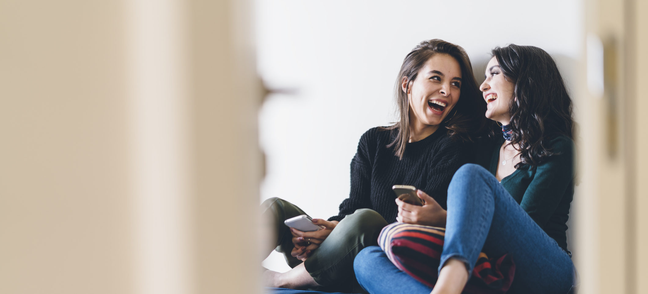 Two young women friends sharing happy time together
