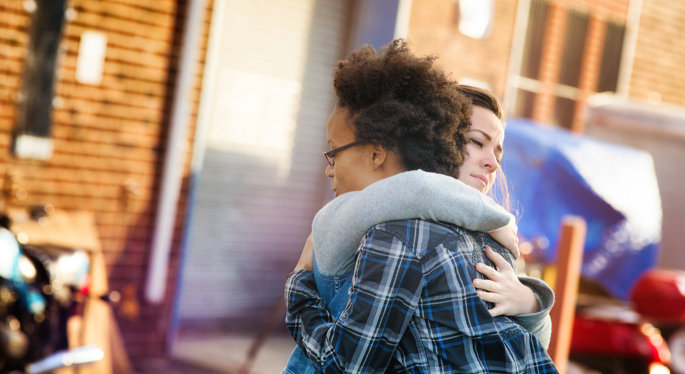 Young women forgiving each other with a hug