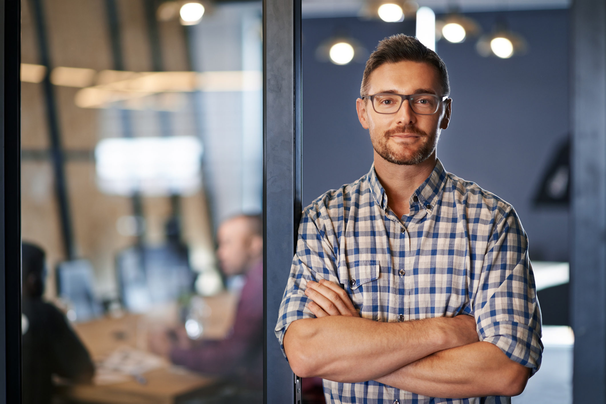 Portrait of a businessman standing with his arms crossed in the office