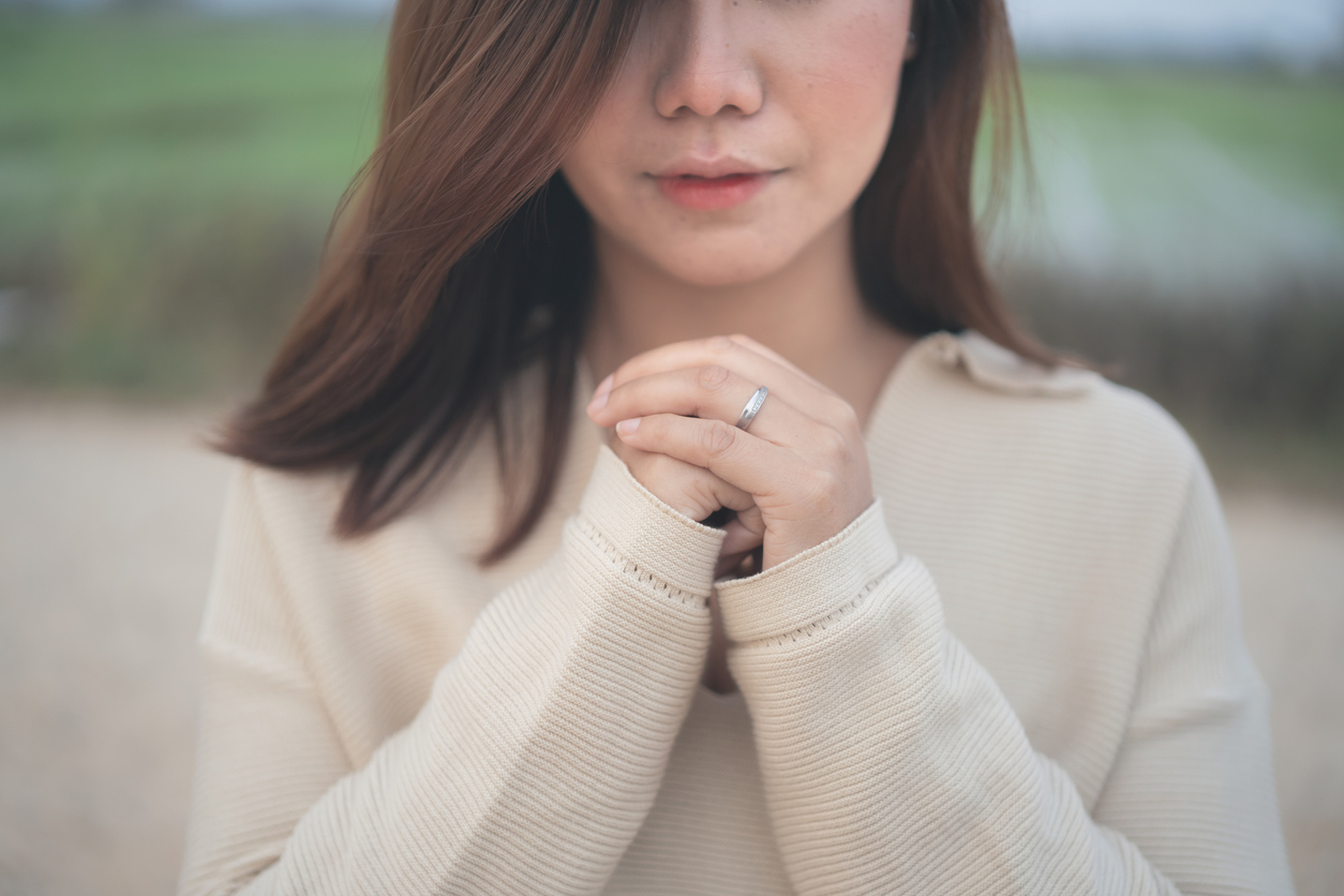 Woman Praying for God to help her forgive after unfair treatment
