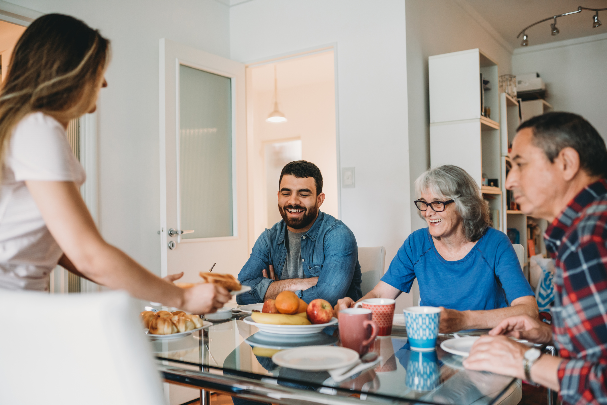 Young couple having breakfast with in-laws
