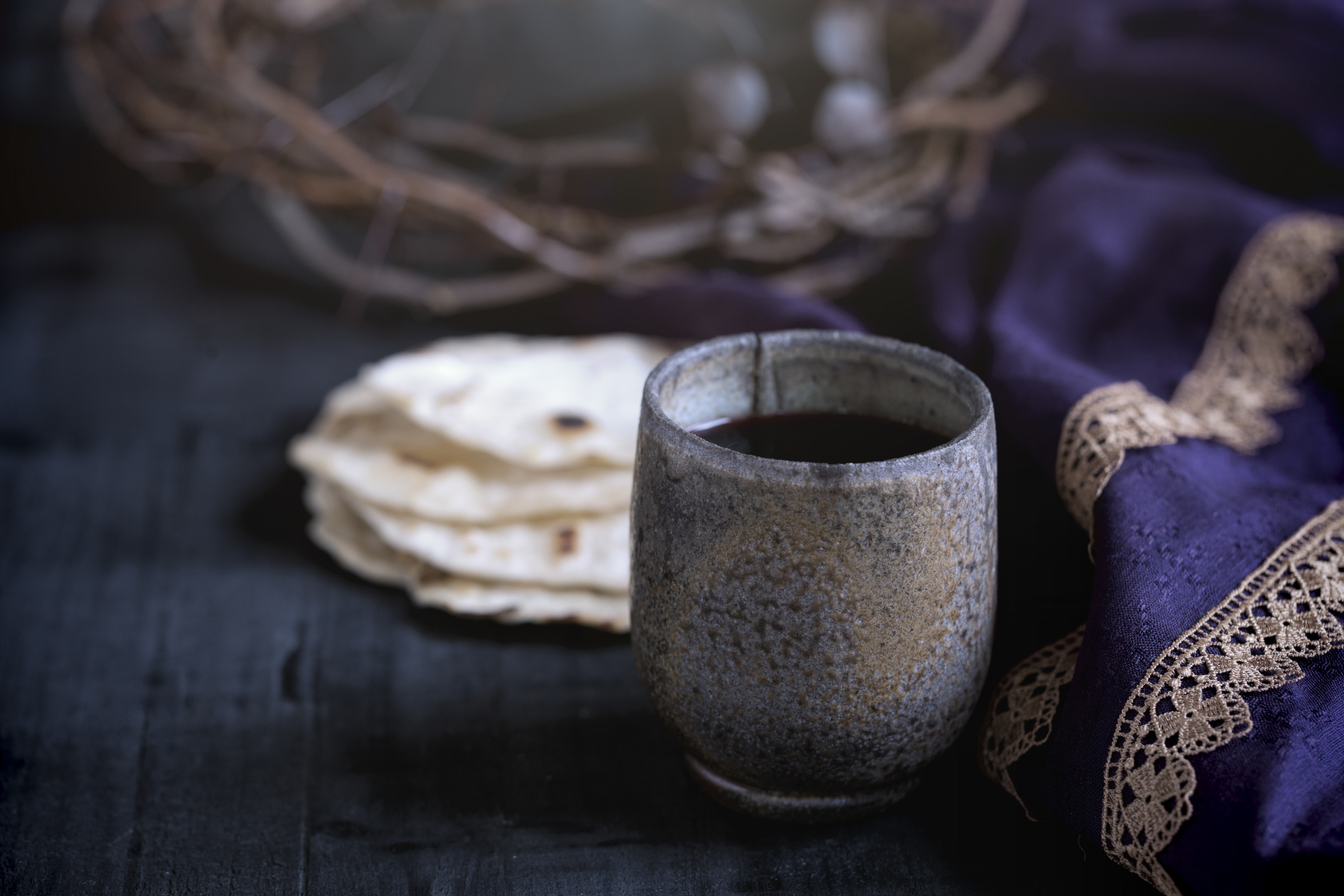 Easter Last Supper Concept: Crown of Thorns & Royal Purple Robe on Old Wood Background