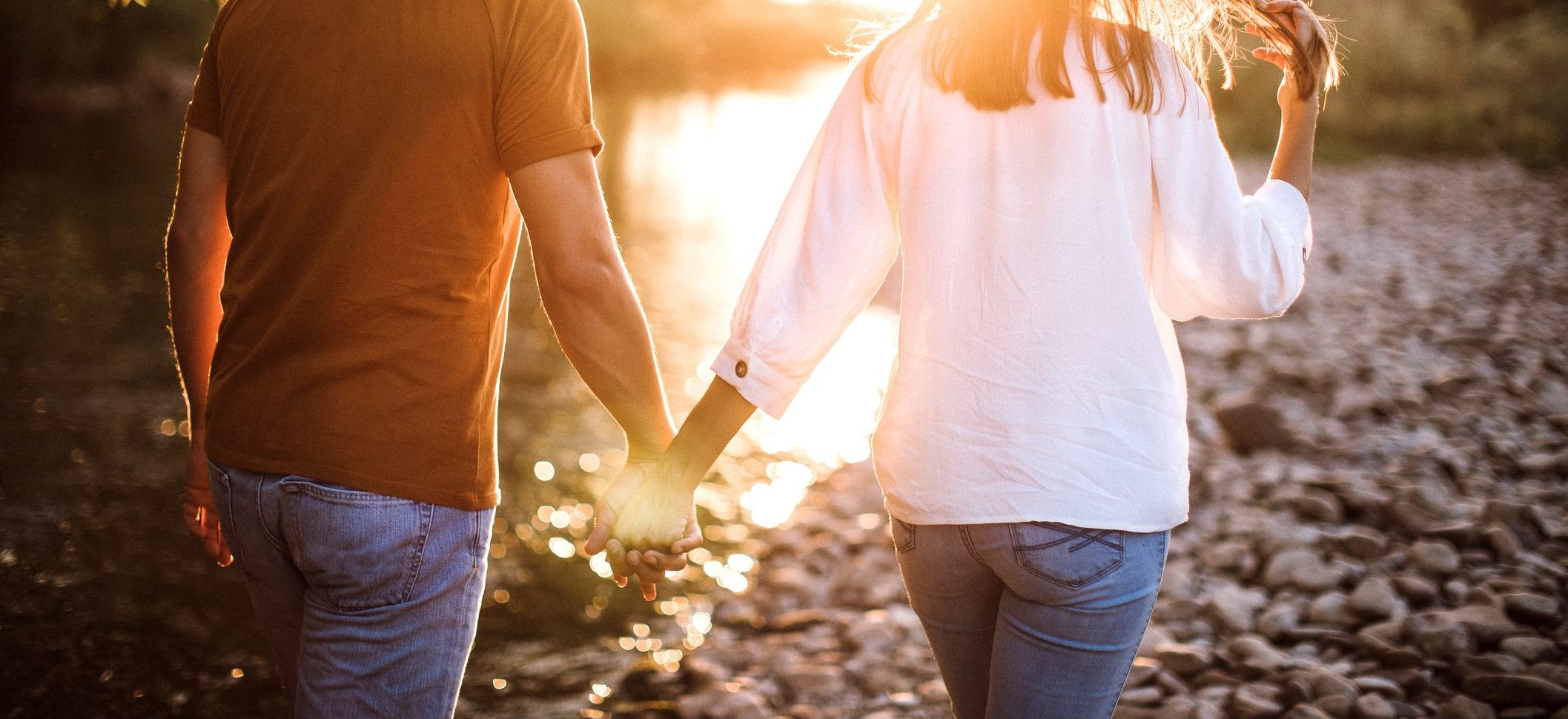 Rear view of couple in walk near river