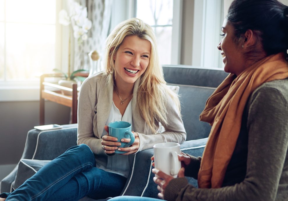 Shot of two young women having coffee together on a relaxing day at home