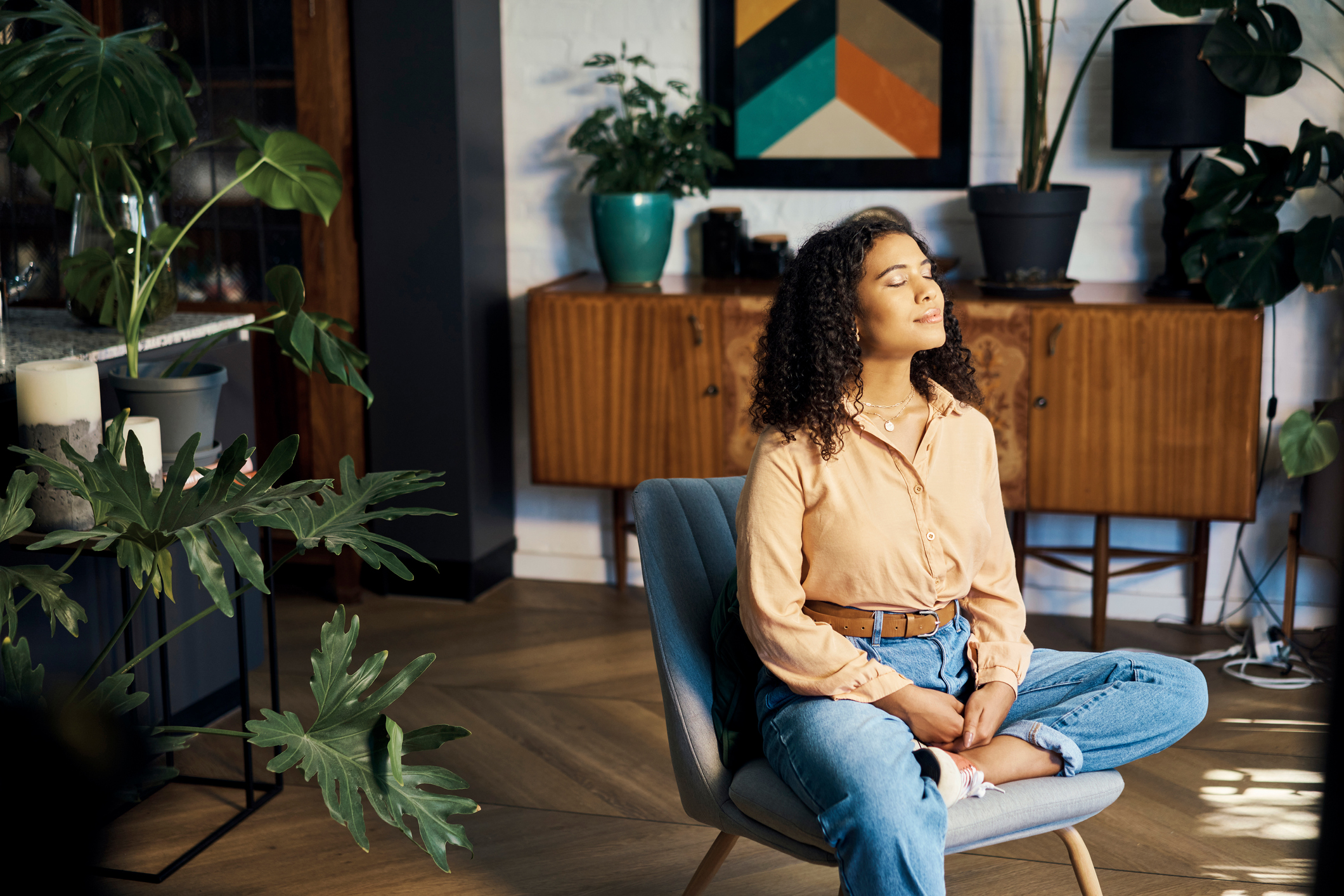 Peace, relax and happy mindset of a woman from Indonesia taking a mind and meditation home break. Happiness of woman on a house living room lounge chair thinking about life