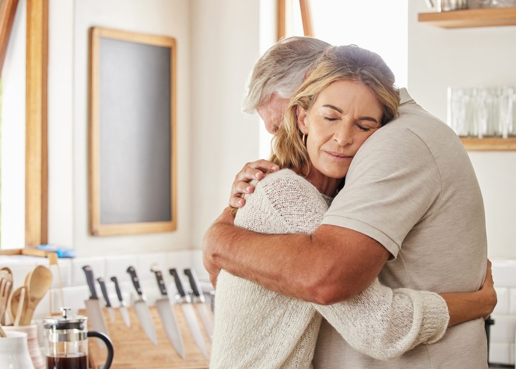 Couple elderly and hug in kitchen in home together