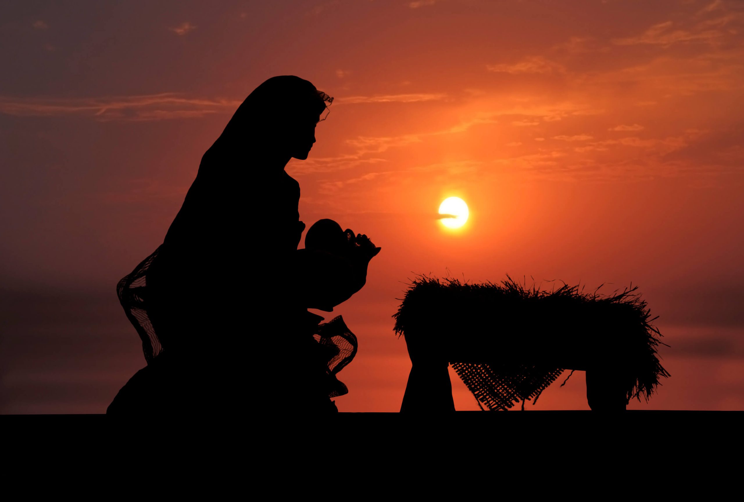 Woman over a bed of hay at sunrise
