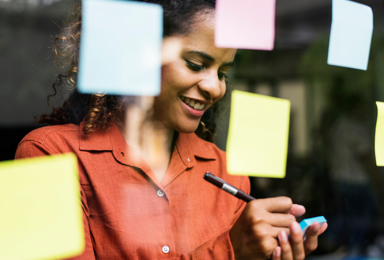 Woman writing on sticky notes