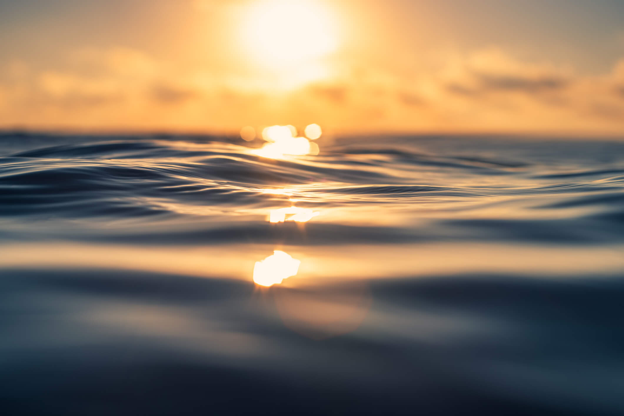 up close shot of the peaceful ocean waves during a sunset