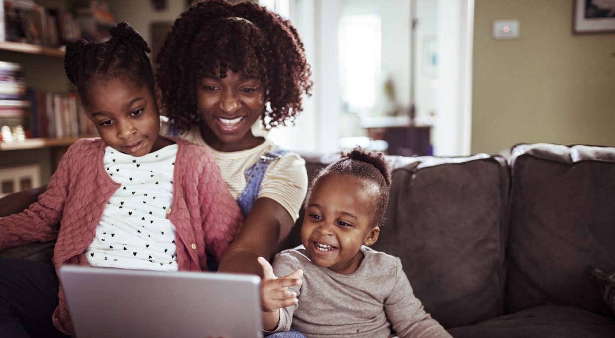 Close up of a mother using a tablet with her daughters