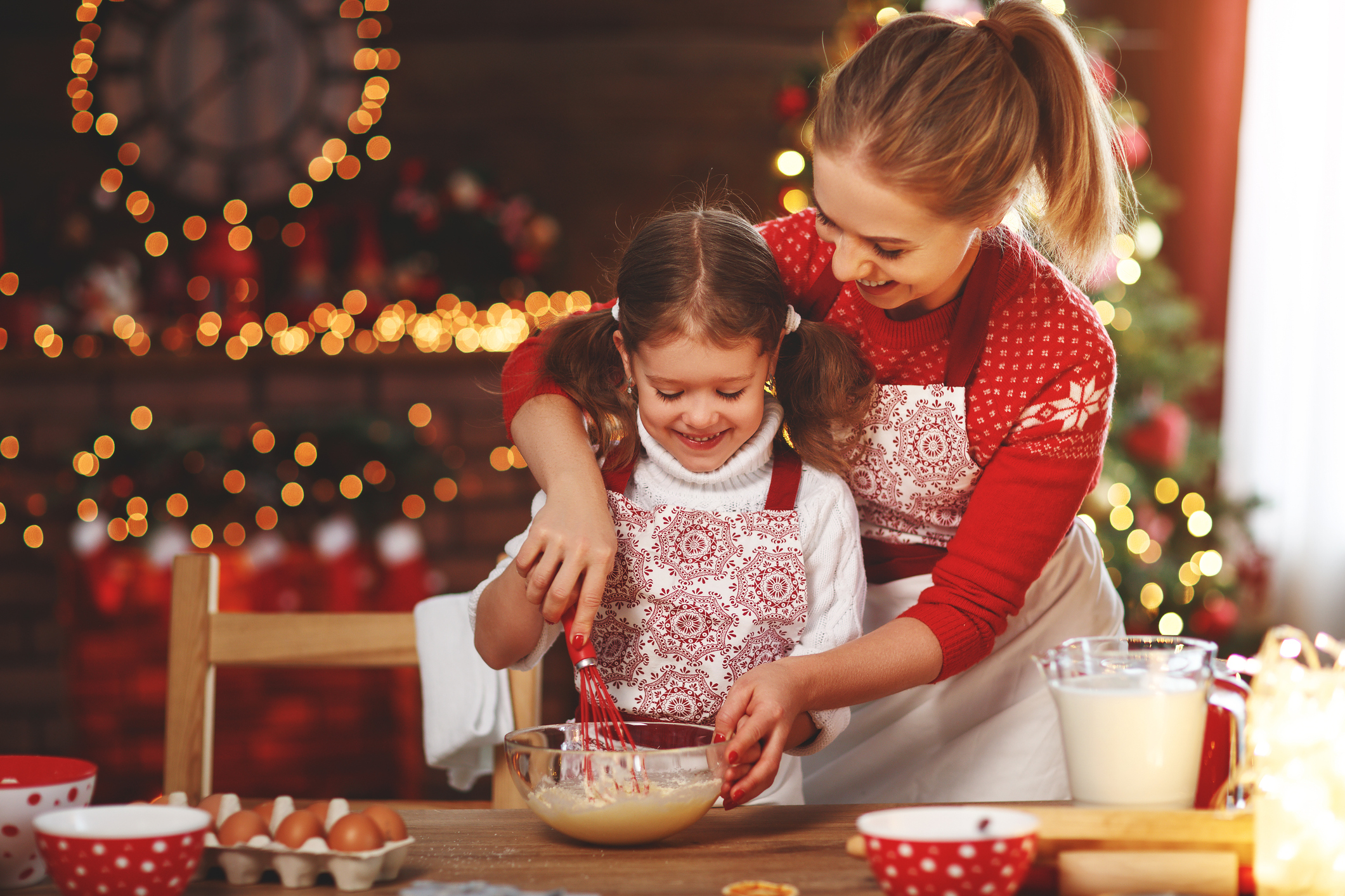Happy mother and child bake christmas cookies