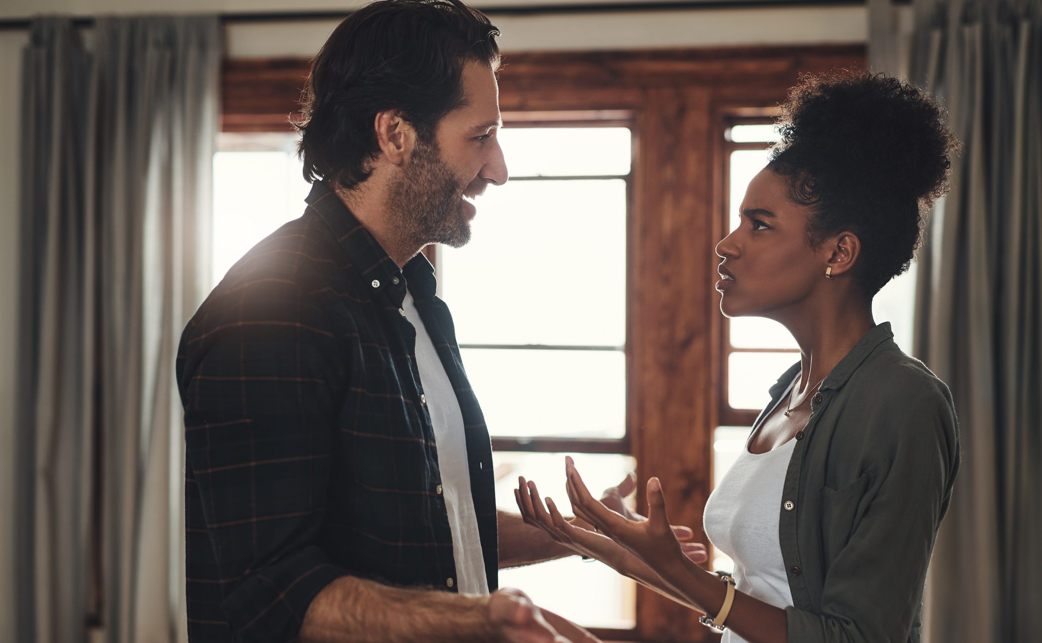Young couple having an intense argument at home