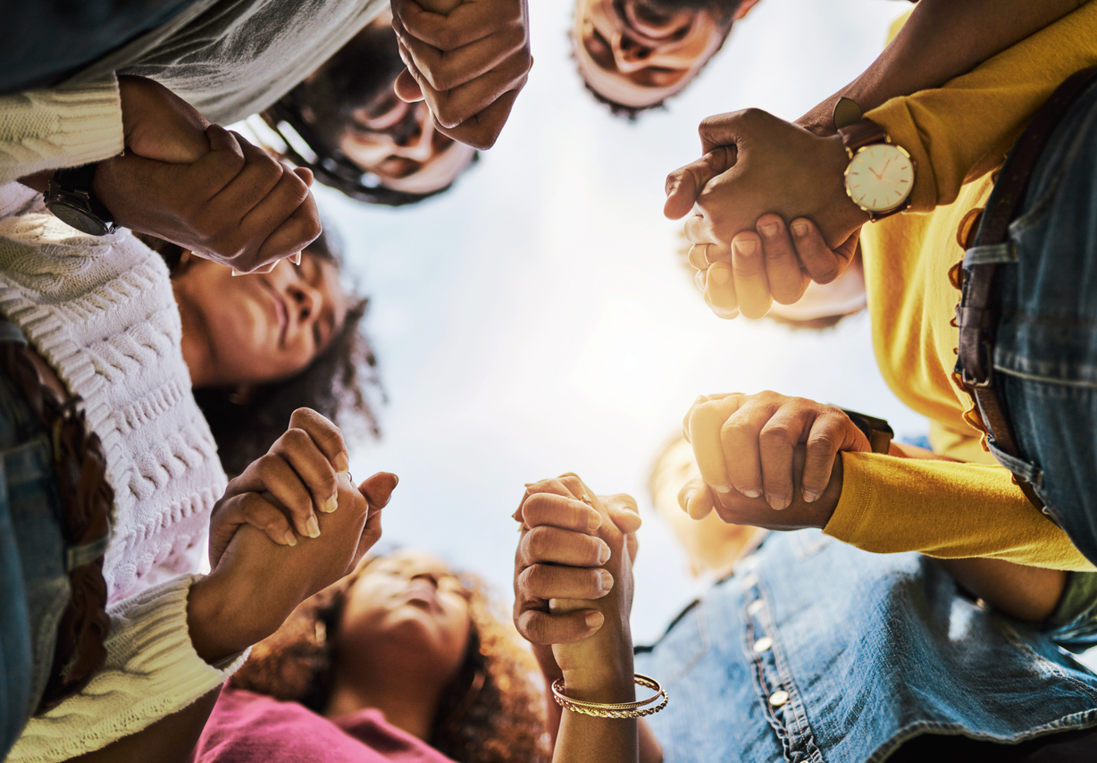 Cropped shot of a group of friends holding hands
