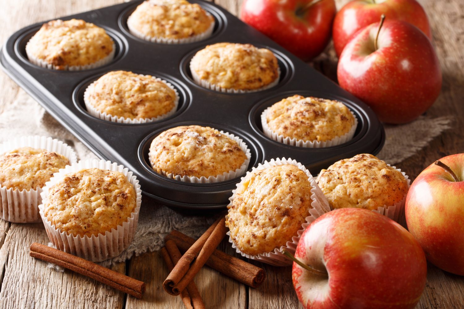 Sweet dessert apple muffins with cinnamon close-up in a baking dish