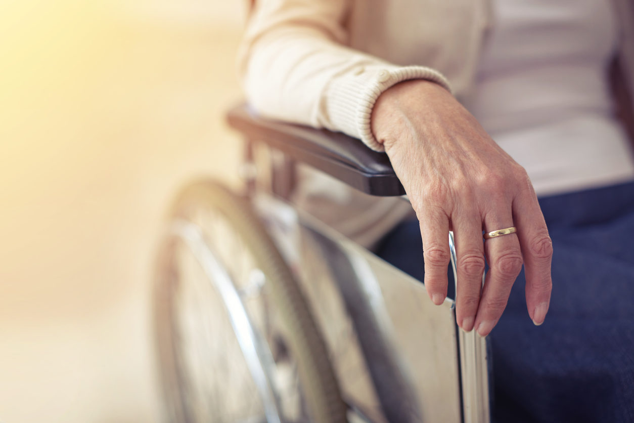 Close-up of the hand of an old woman in a wheelchair