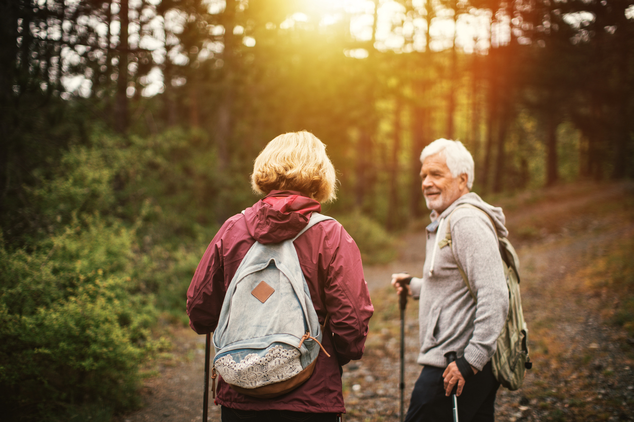 Older couple hiking in the woods