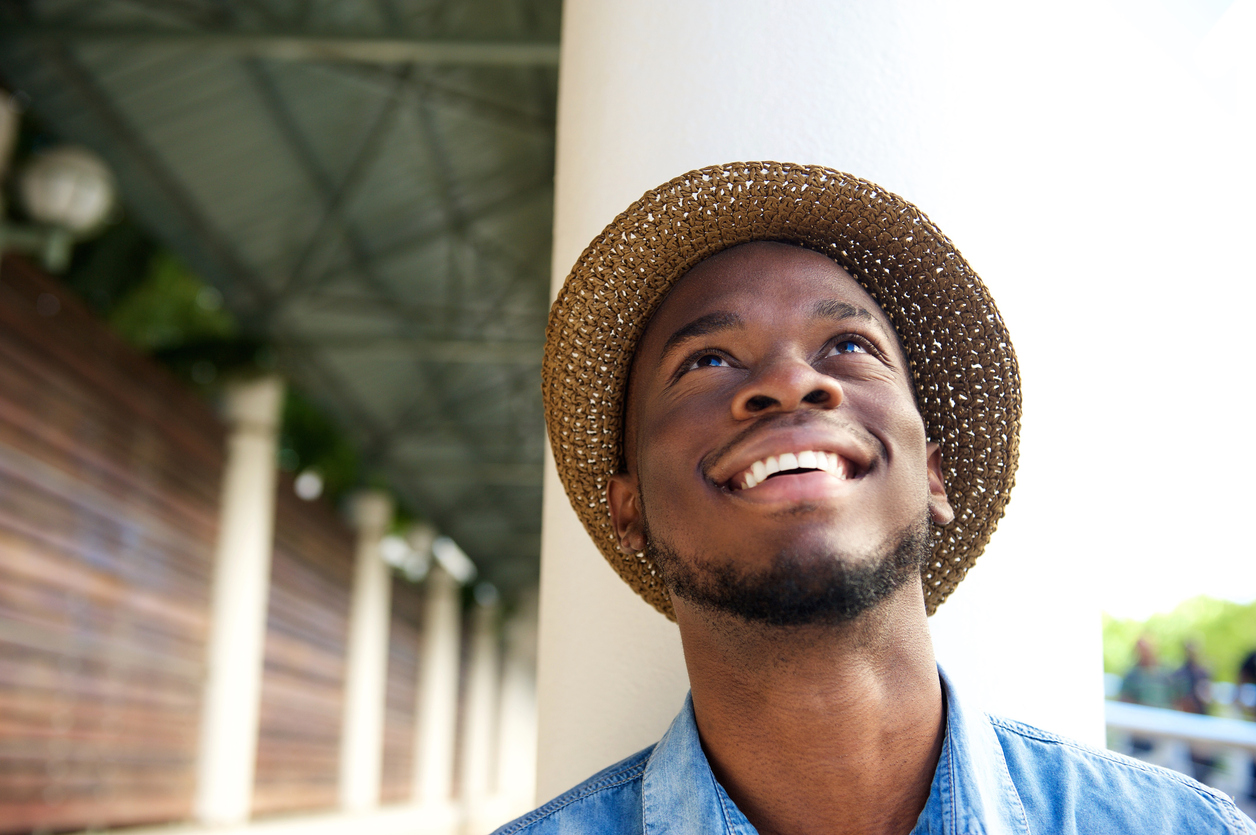 A smiling man looking at the sky