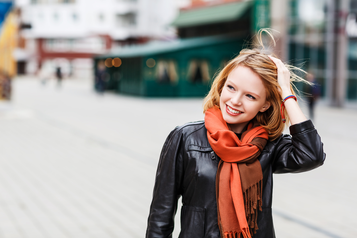 A young woman in an orange scarf