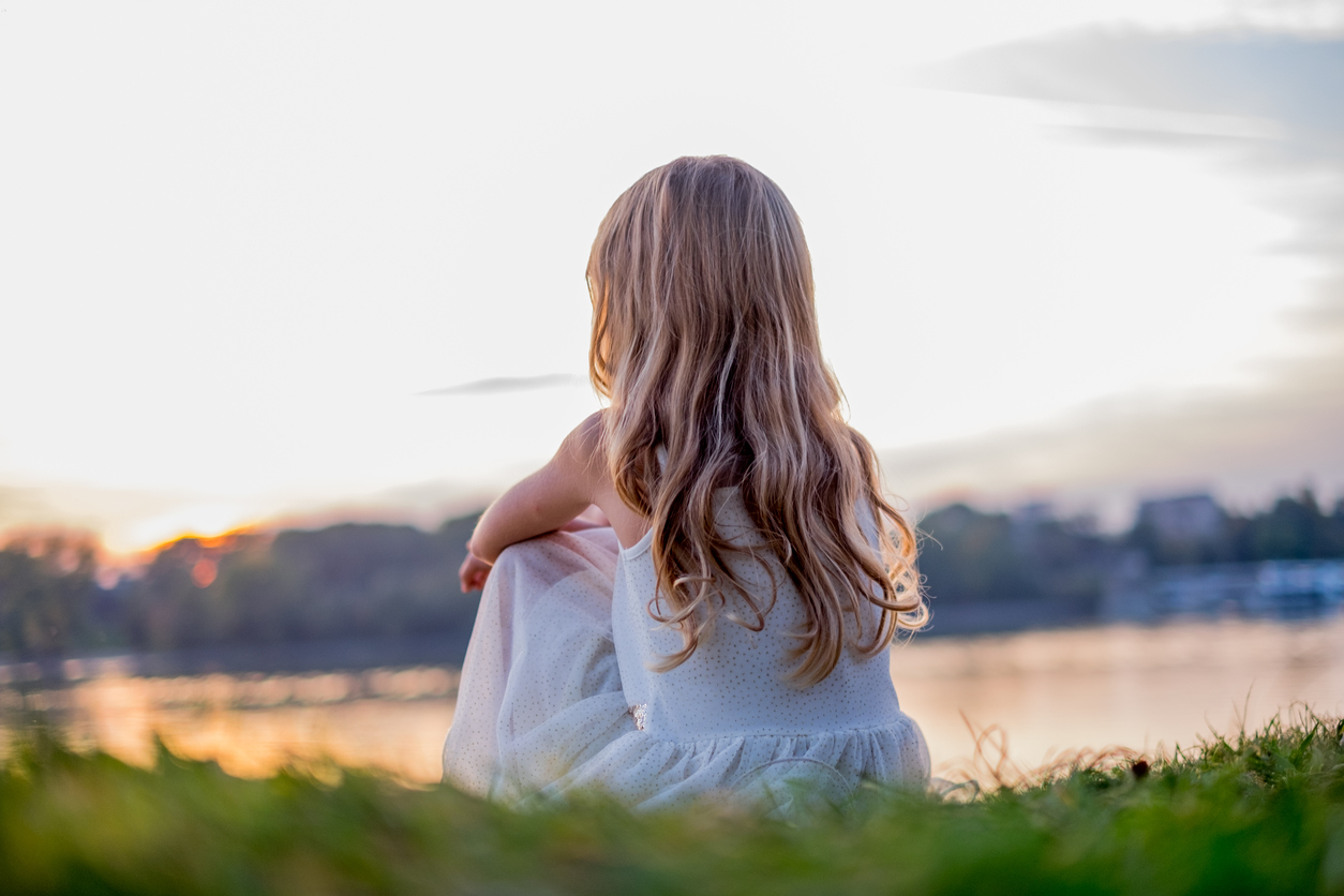 A girl sitting in a meadow