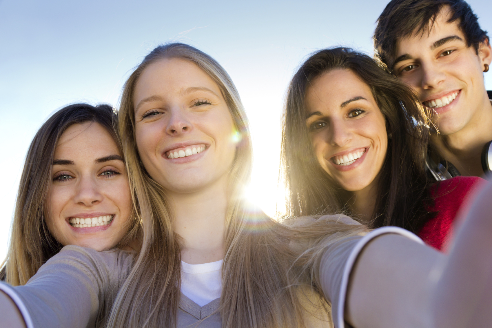 A group of friends taking photos with a smartphone