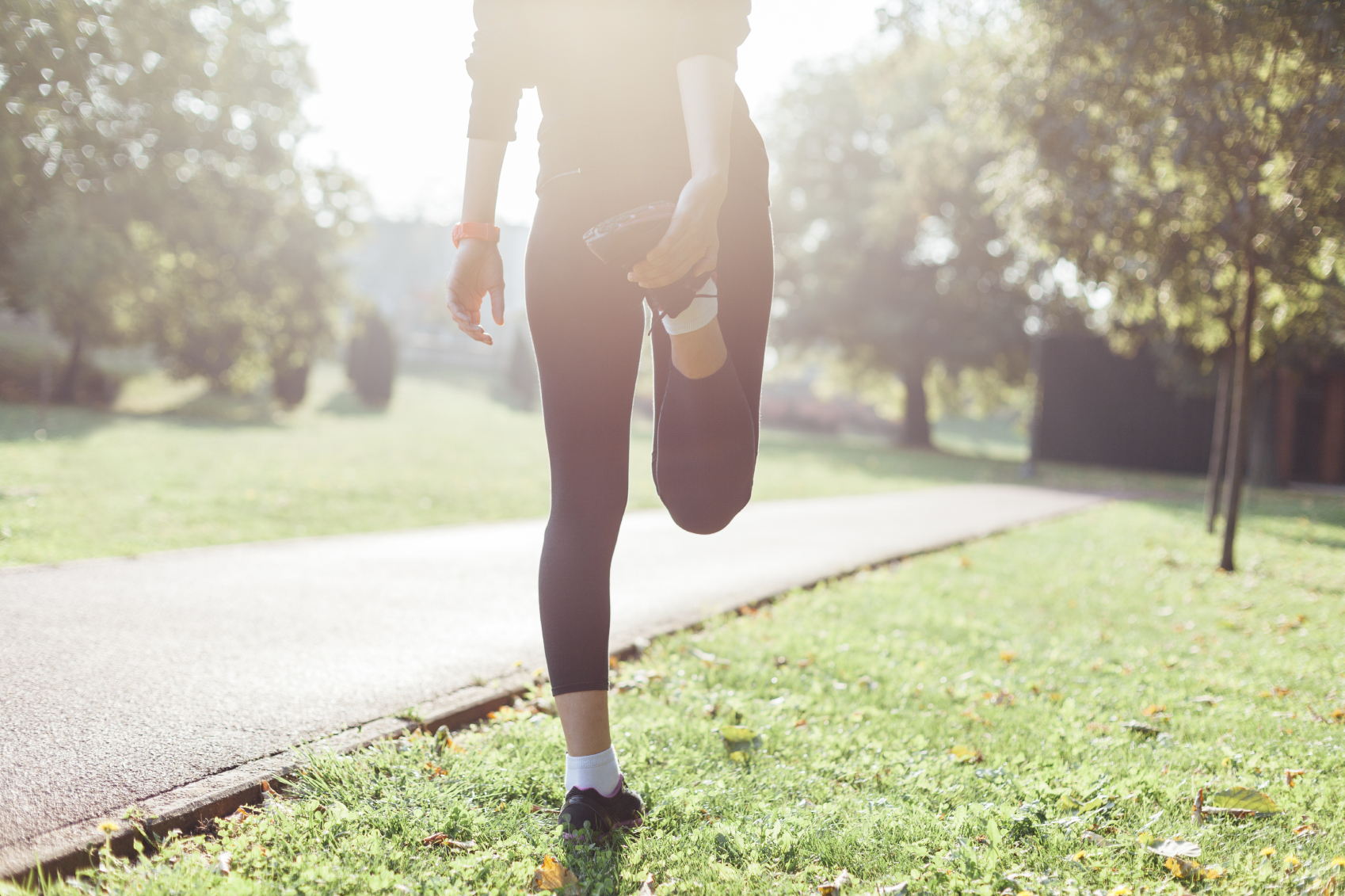 A woman stretches in the park