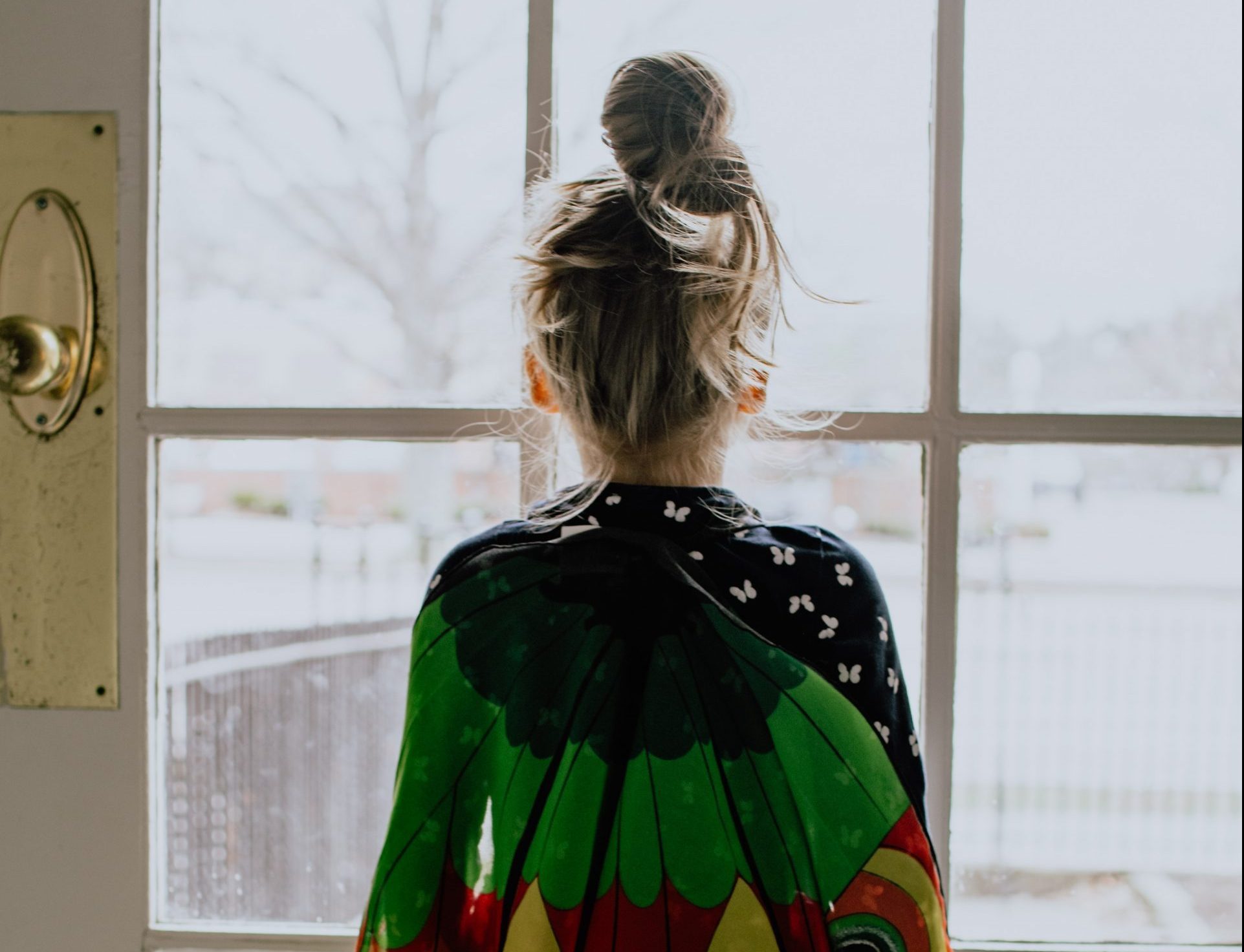 A little girl looking out the window
