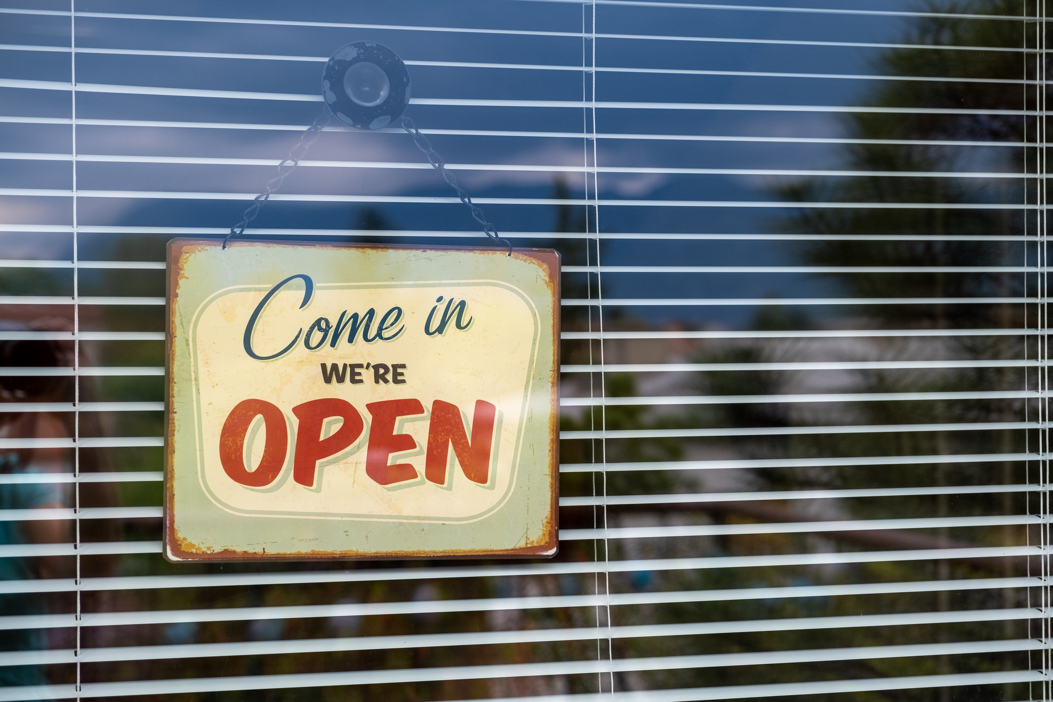 Come in we're OPEN sign on Entrance Window