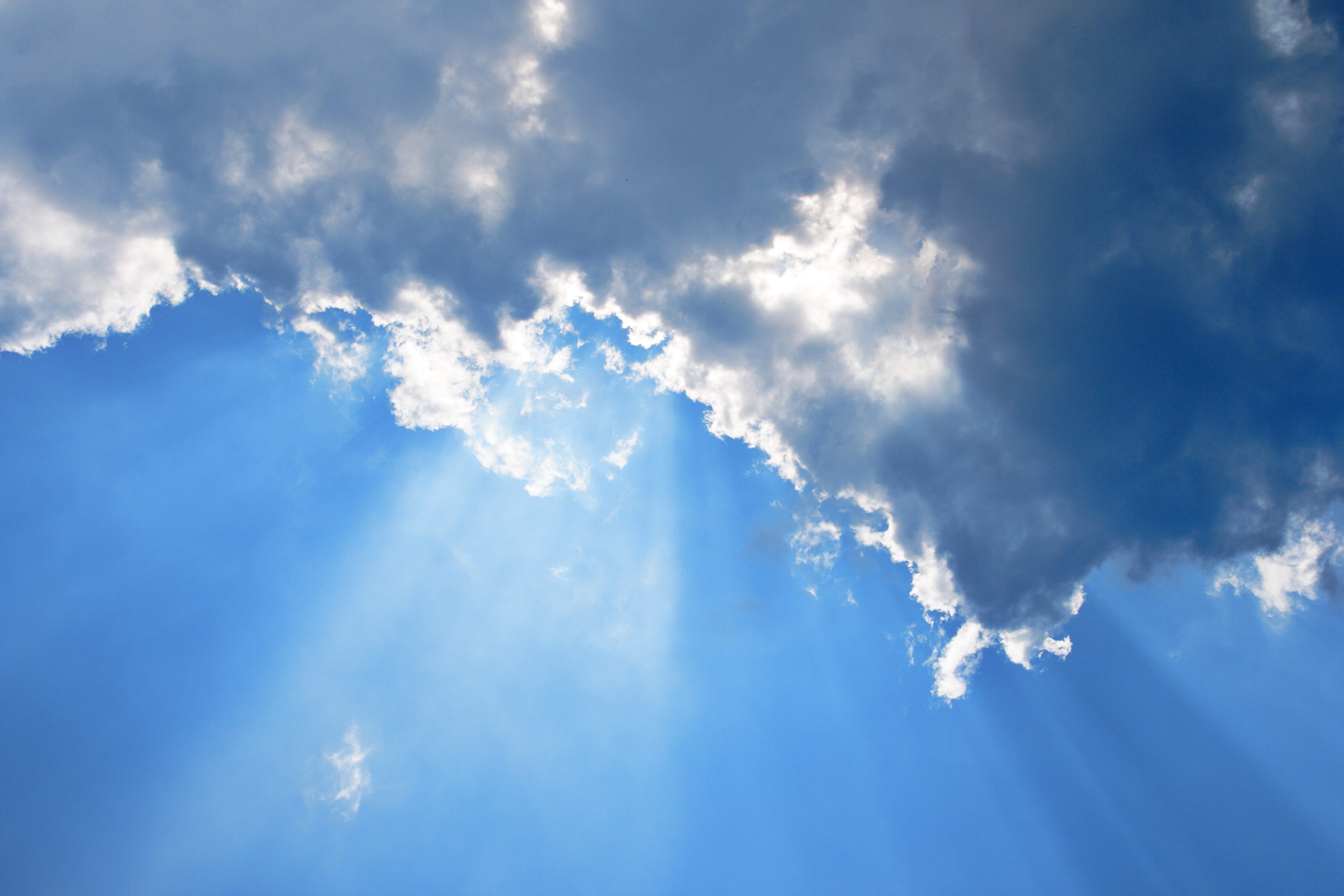 The sun emerging from behind the clouds
