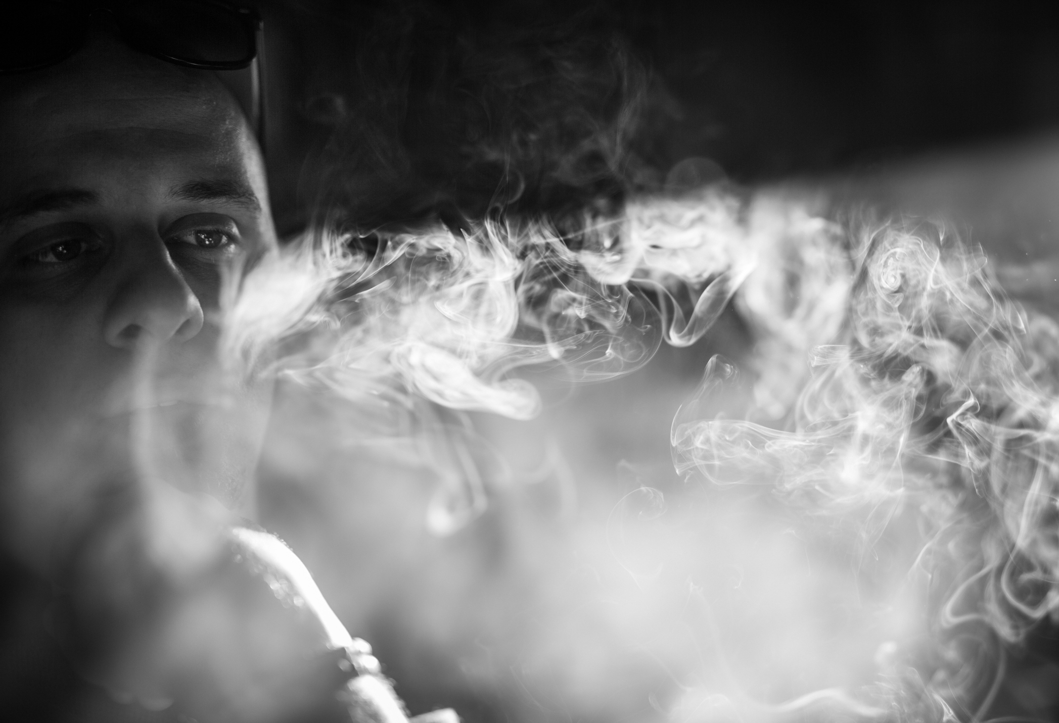 Man smoking cigarette in pub
