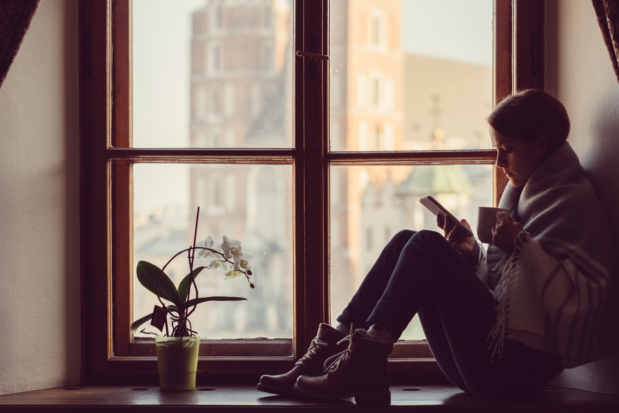 Woman on the window texting