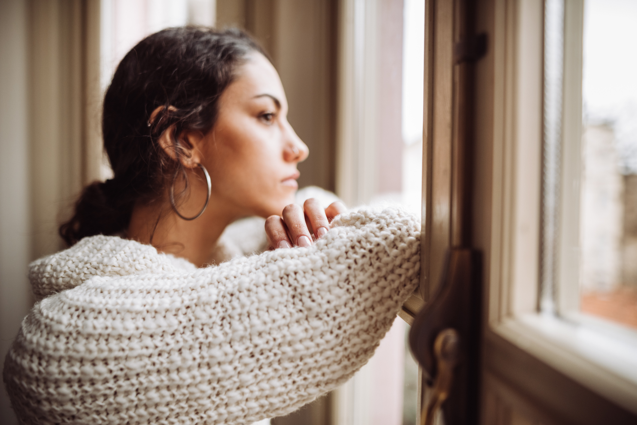 Prayerful woman in front of the window