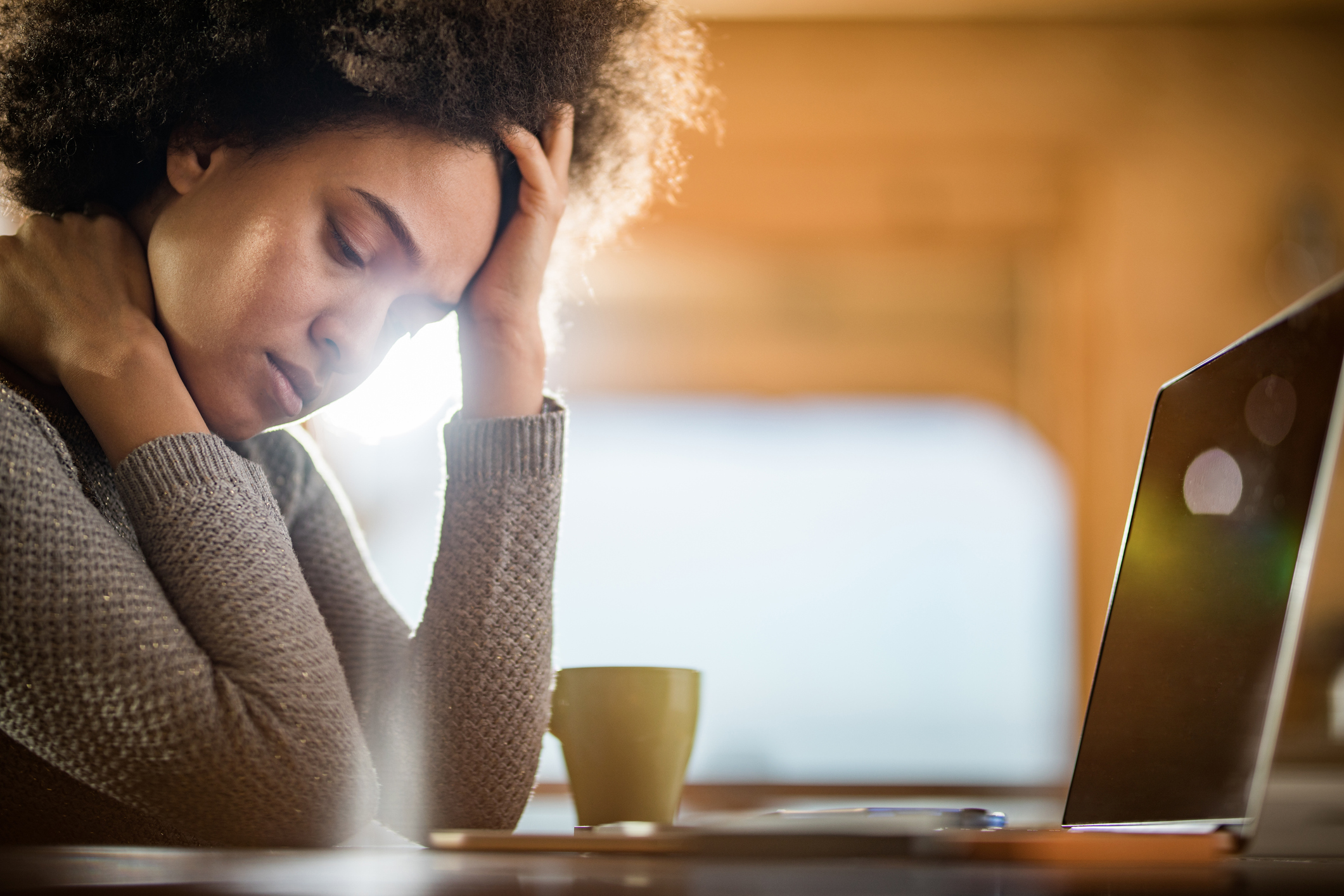 Young African American woman feeling depressed at home