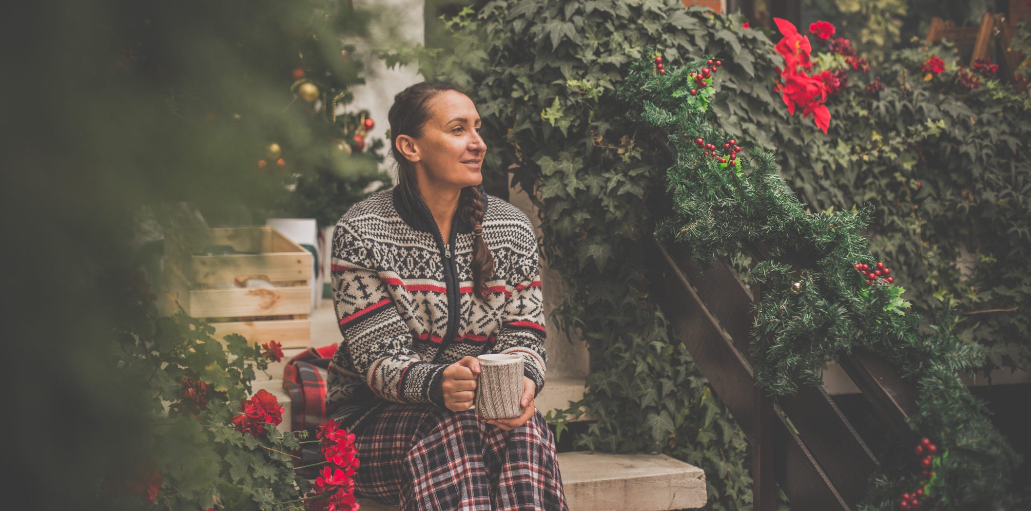 Woman drinking tea outdoors in Christmas time