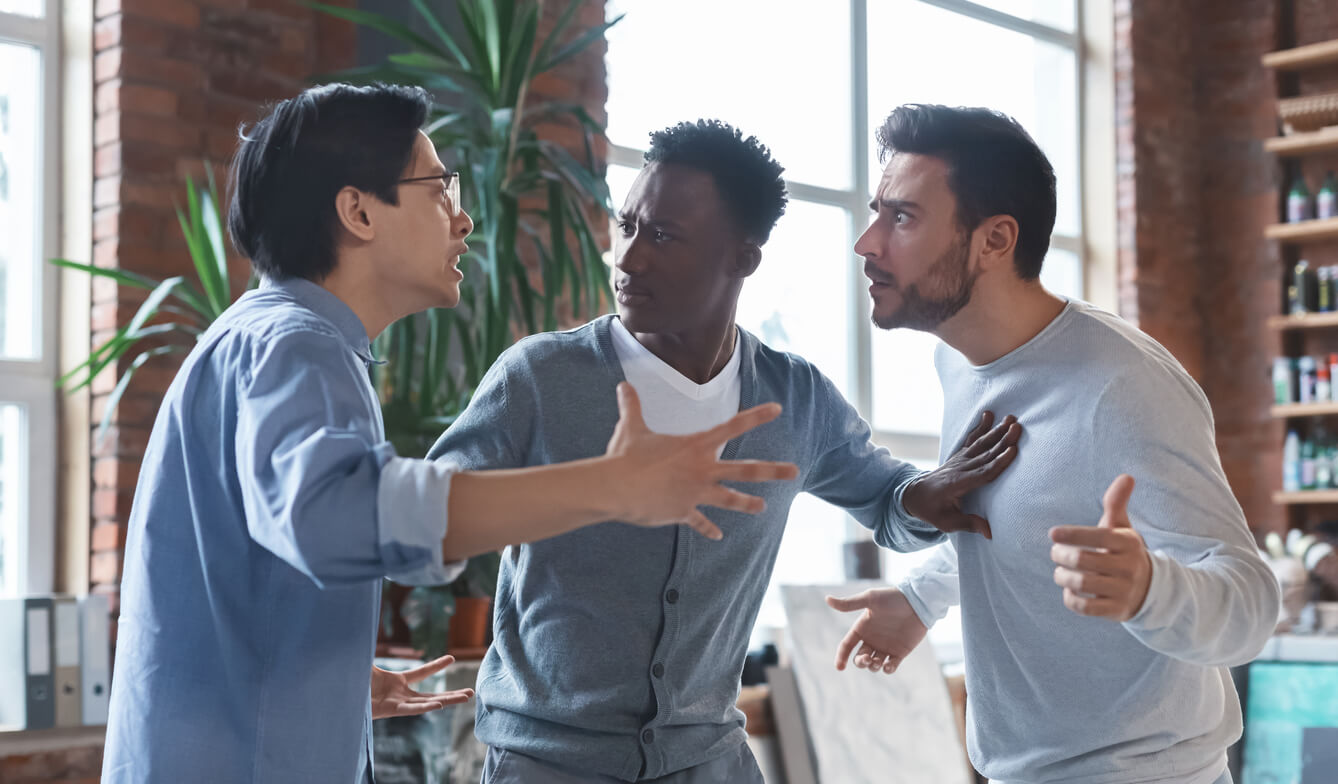 Multiracial coworkers having quarrel in office