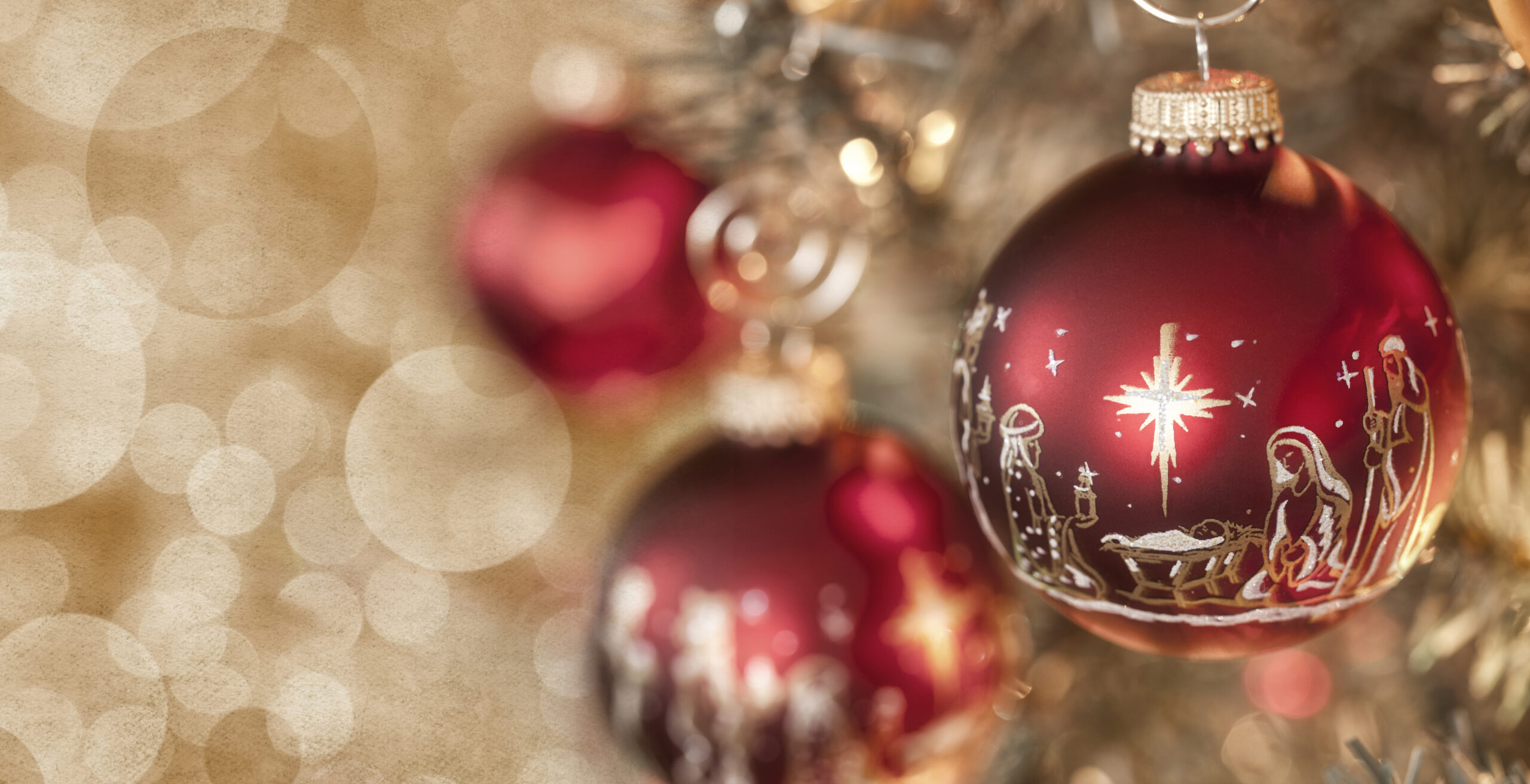 Red Christmas ornaments with a nativity scene