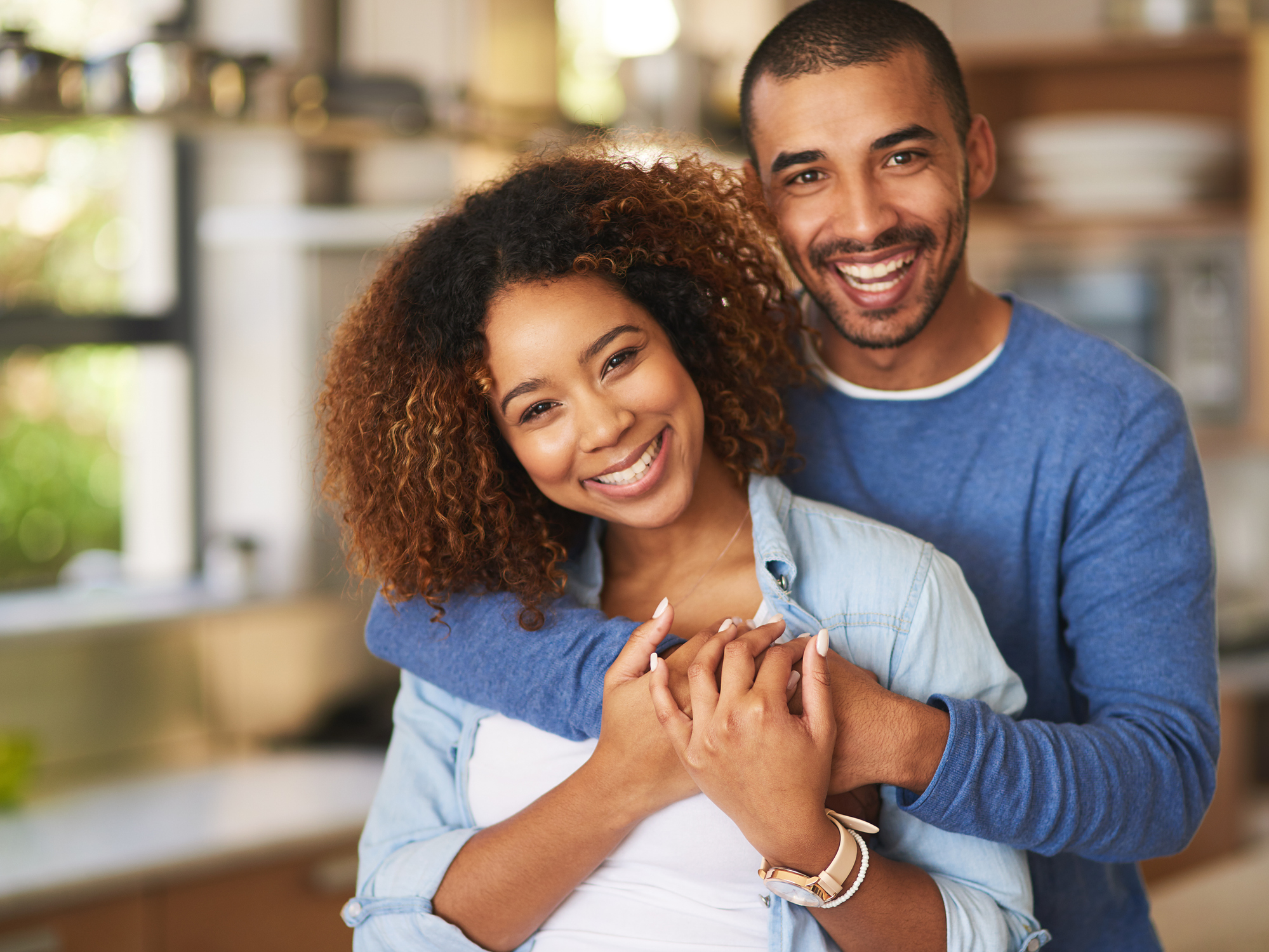 Portrait of a happy young couple in their kitchen at home