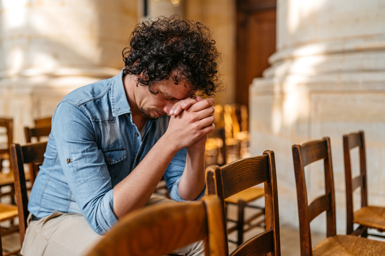 Young Man praying in the church in Paris